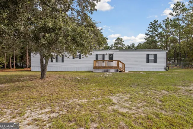 a backyard of a house with table and chairs