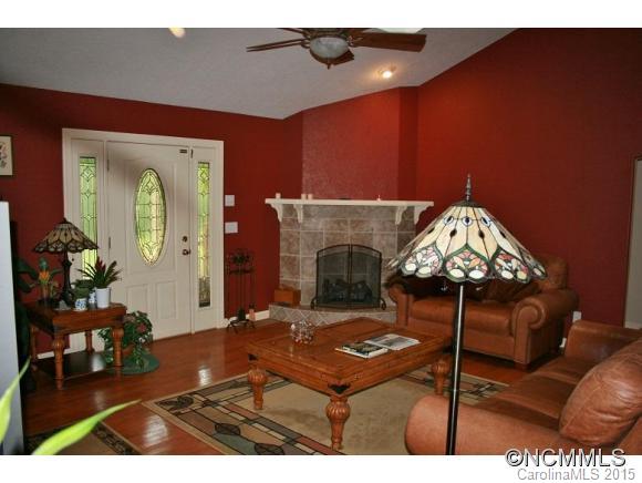 2136 Coopers Gap Road Rutherfordton, NC 28139 - Photo 4 of 24 a living room with furniture a fireplace and a chandelier