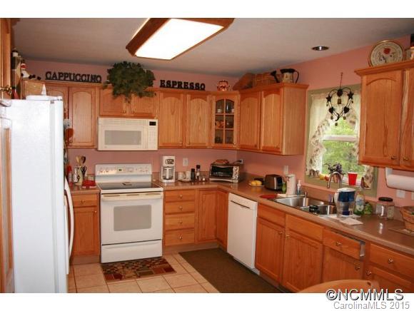 2136 Coopers Gap Road Rutherfordton, NC 28139 - Photo 7 of 24 a kitchen with stainless steel appliances a stove a sink a refrigerator and cabinets