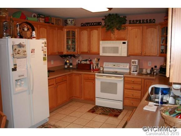 2136 Coopers Gap Road Rutherfordton, NC 28139 - Photo 8 of 24 a kitchen with stainless steel appliances a sink a stove a refrigerator and cabinets