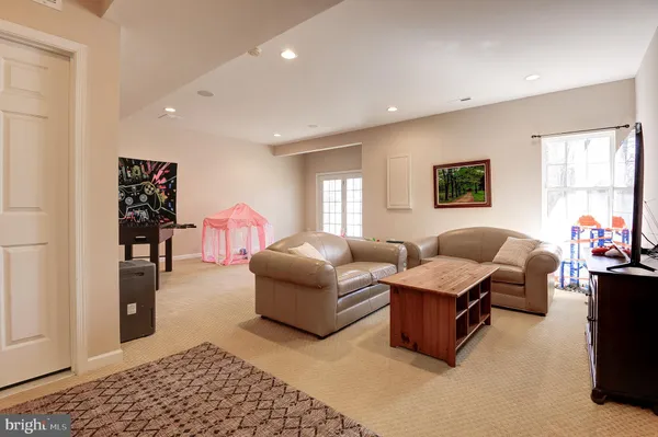 a view of a livingroom with furniture wooden floor windows and a chandelier