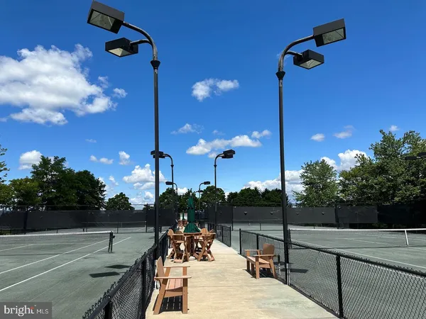 a view of a cafe with a table and chairs under an umbrella