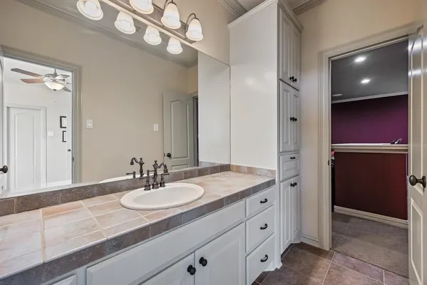 a bathroom with a sink a vanity and a mirror