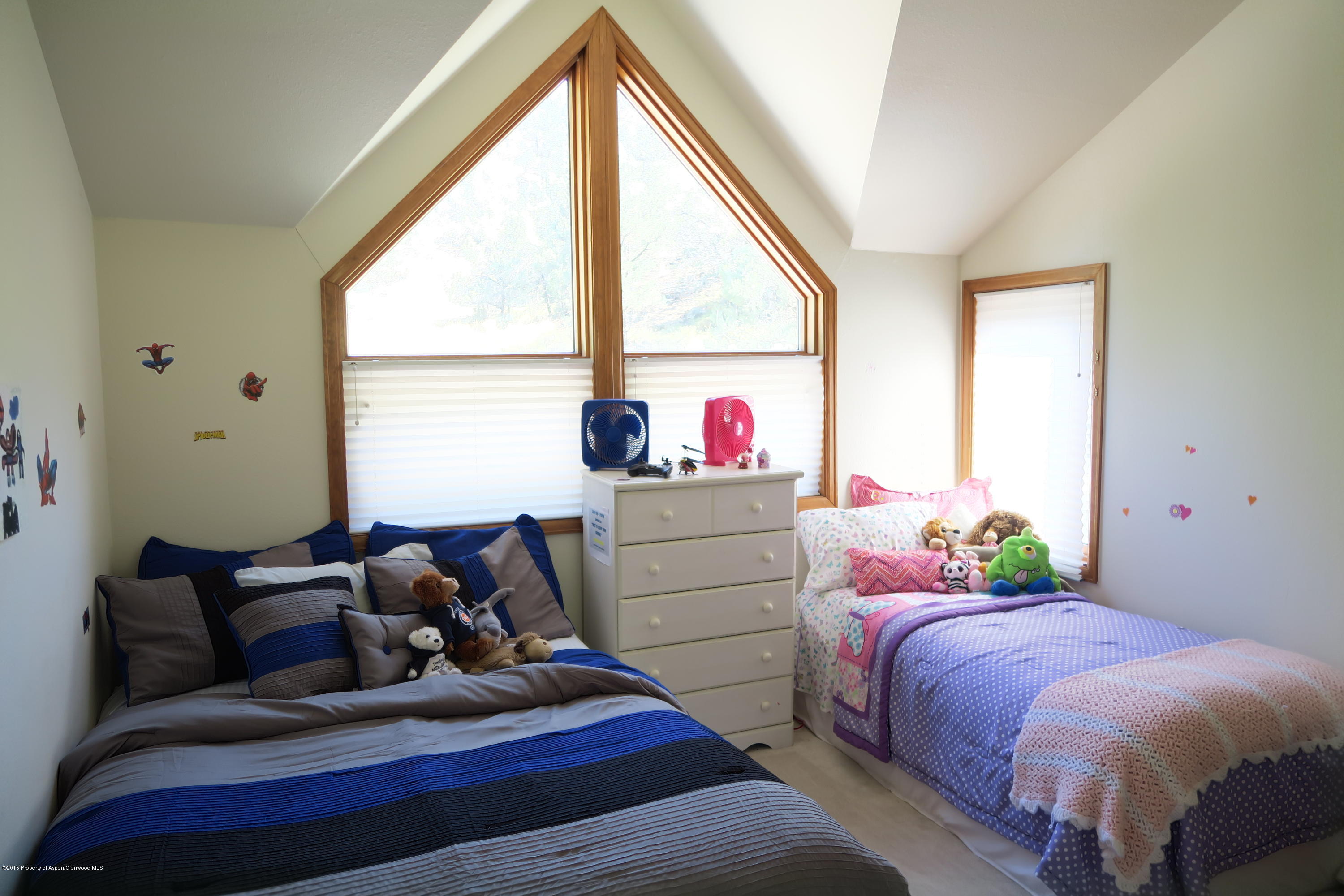 105 Silverado Drive Basalt, CO 81621 - Photo 11 of 13 a bedroom with a bed and windows