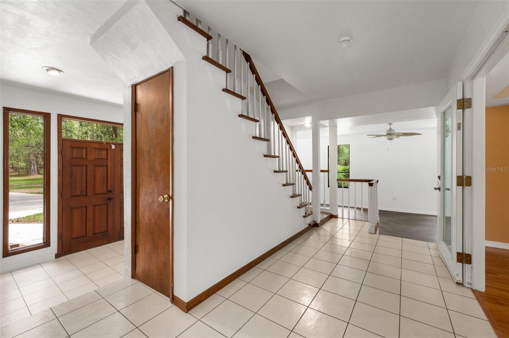 4703 Northwest 124th Street Gainesville, FL 32606 - Photo 8 of 55 a view of entryway with stairs and a rug