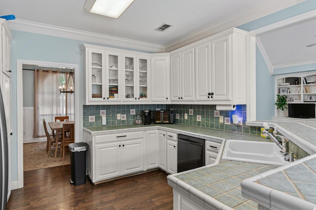 176 County Road 3282 Quitman, TX 75783 - Photo 11 of 35 a kitchen with white cabinets and sink