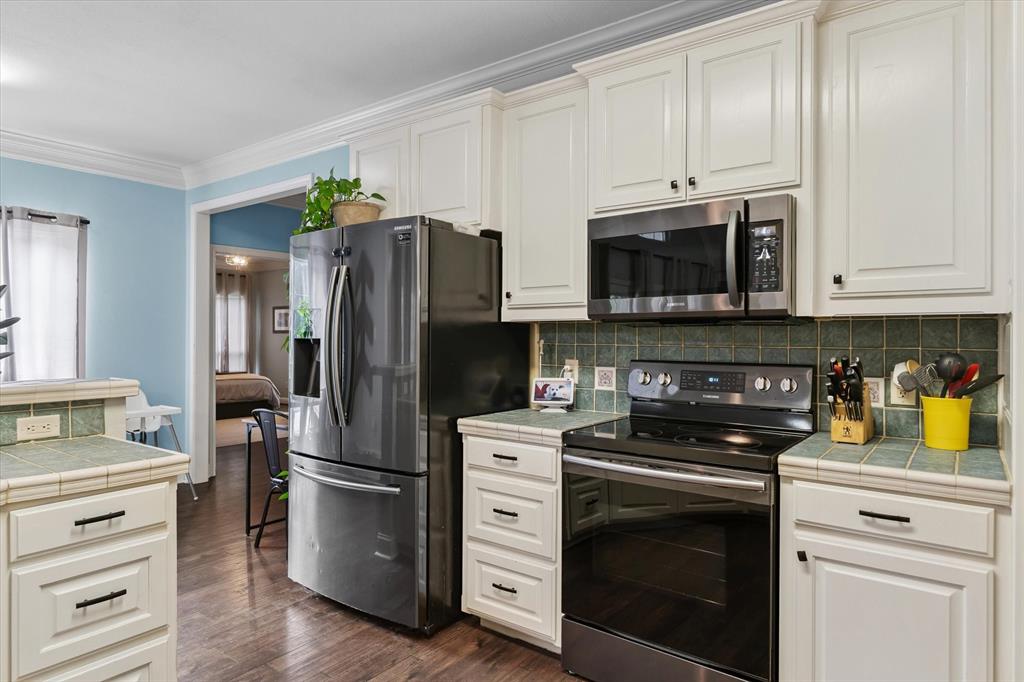 176 County Road 3282 Quitman, TX 75783 - Photo 13 of 35 a kitchen with granite countertop white cabinets and stainless steel appliances