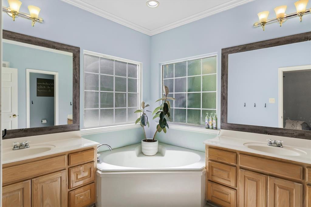 176 County Road 3282 Quitman, TX 75783 - Photo 18 of 35 a bathroom with a sink double vanity and a shower