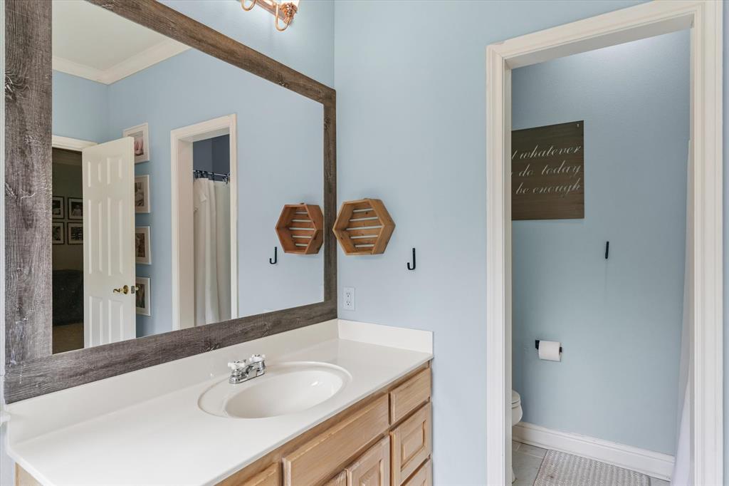 176 County Road 3282 Quitman, TX 75783 - Photo 19 of 35 a bathroom with a sink and a mirror