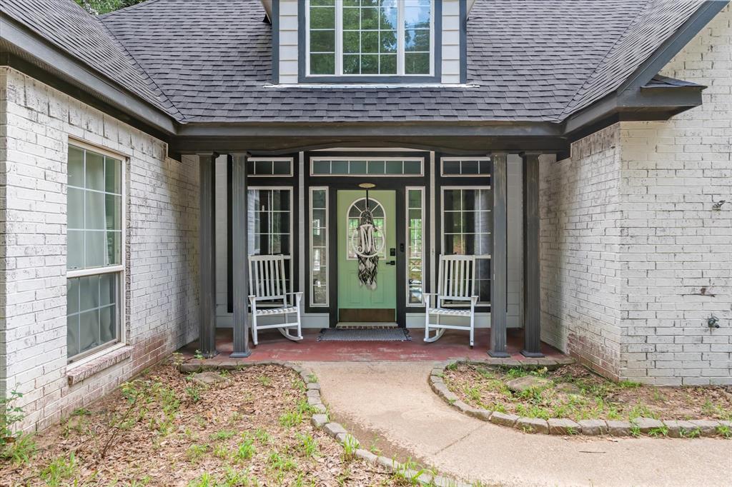 176 County Road 3282 Quitman, TX 75783 - Photo 2 of 35 a front view of a house with a porch