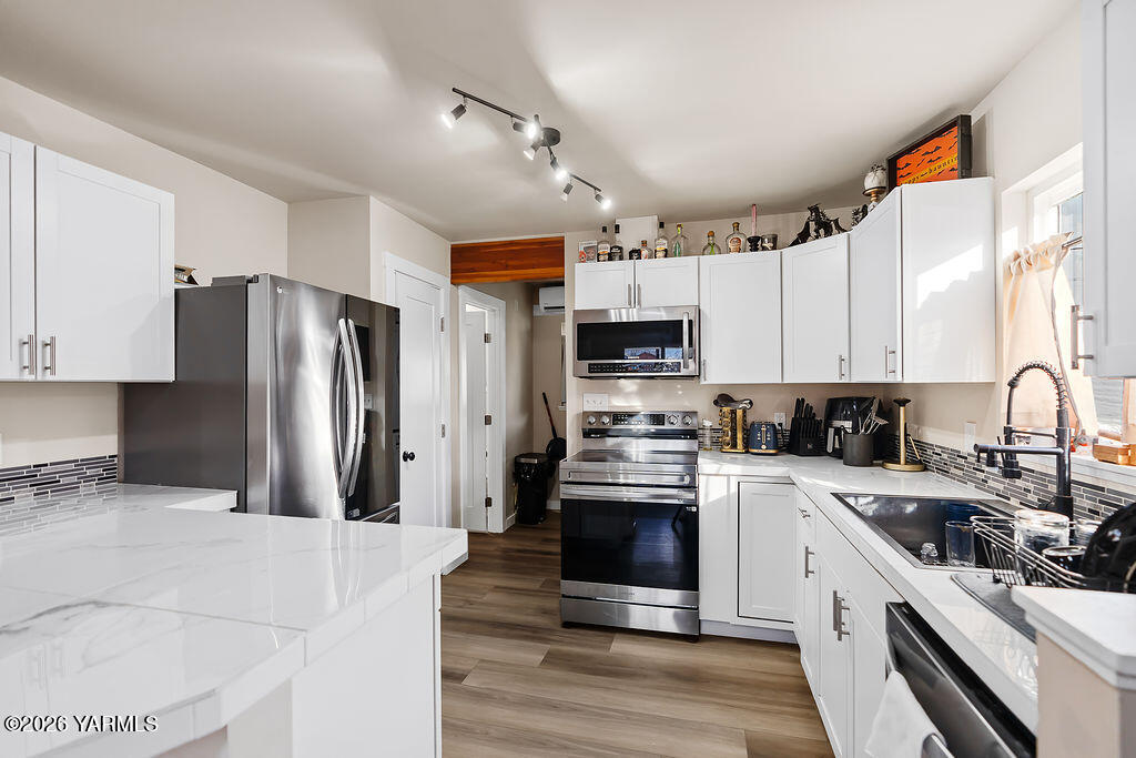 603 Cornell Avenue Yakima, WA 98902 - Photo 11 of 25 a kitchen with stainless steel appliances a refrigerator sink and cabinets