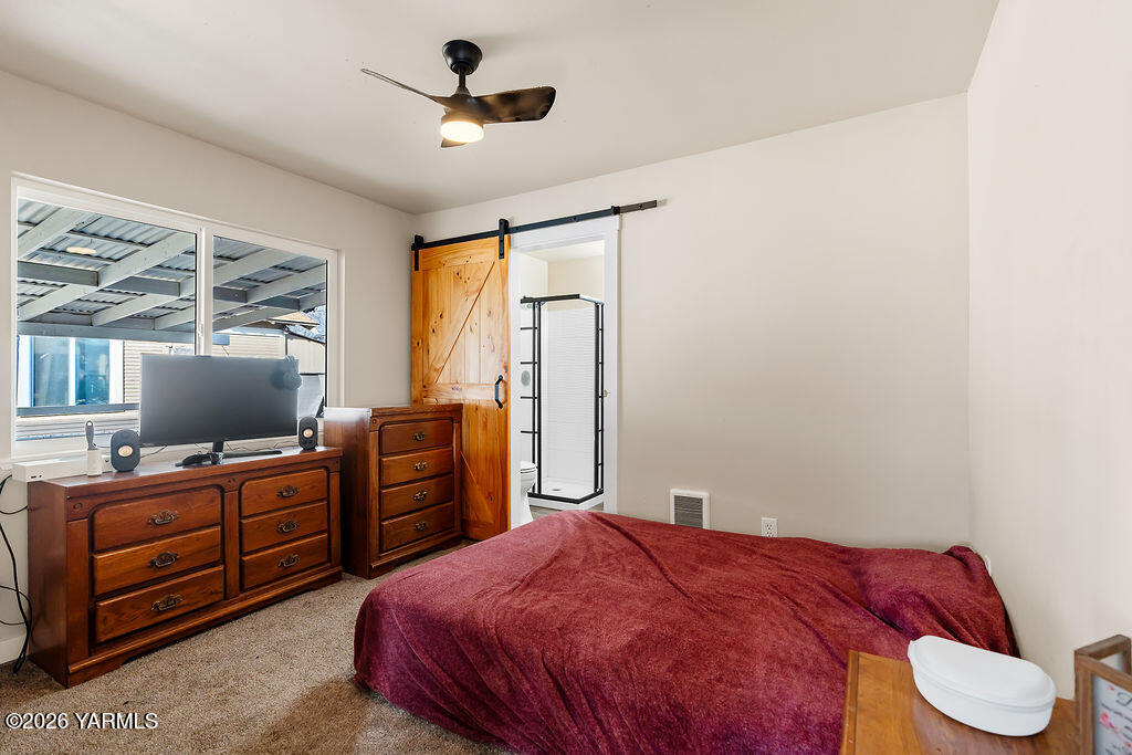 603 Cornell Avenue Yakima, WA 98902 - Photo 15 of 25 a bedroom with a bed and furniture with a flat tv screen