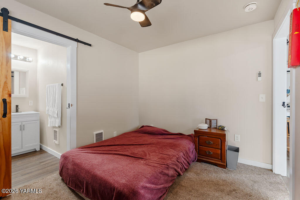 603 Cornell Avenue Yakima, WA 98902 - Photo 16 of 25 a bedroom with a bed and a table