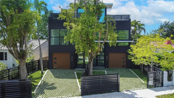 an aerial view of a house with a yard