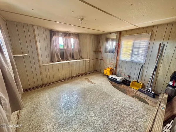 a view of a dry yard with wooden fence