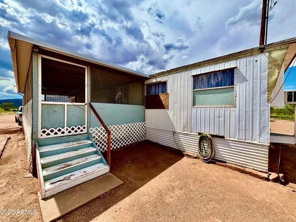 a view of a backyard with sitting area