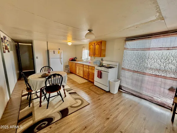a view of a livingroom with furniture wooden floor and windows