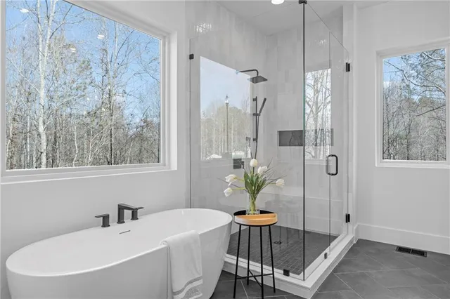 a bathroom with a tub sink and mirror