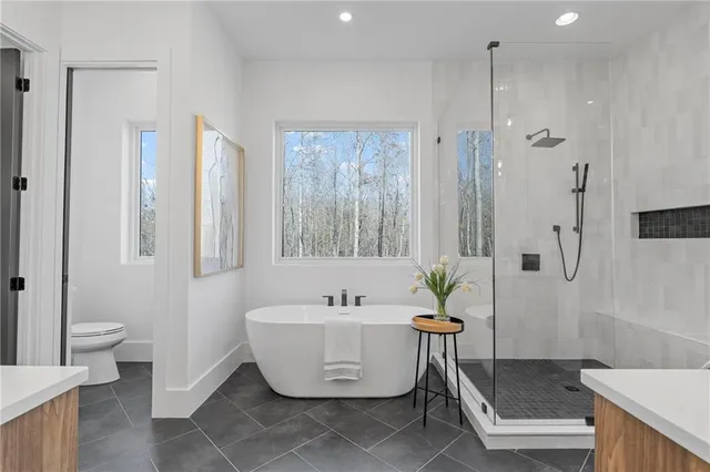 a spacious bathroom with a bathtub and shower