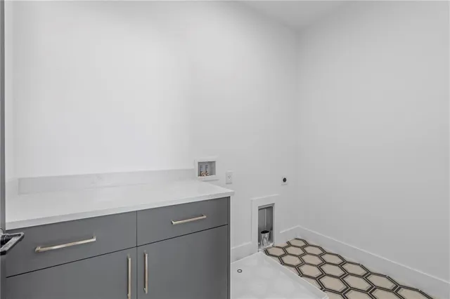 a bedroom with a bed and a lamp on dresser