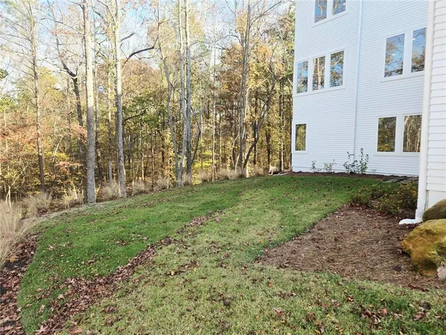 a view of a backyard with large trees
