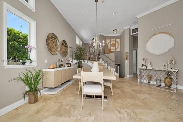 a living room with furniture a window and a chandelier