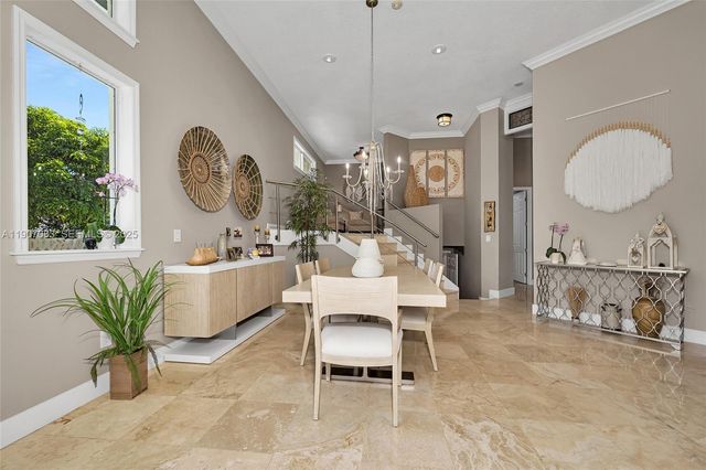 a living room with furniture a window and a chandelier
