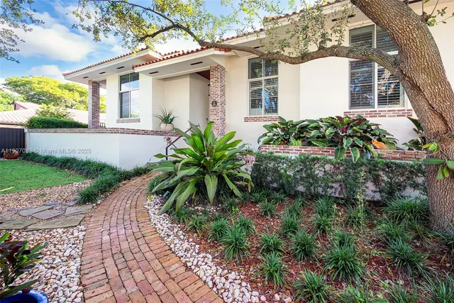 a front view of a house with garden