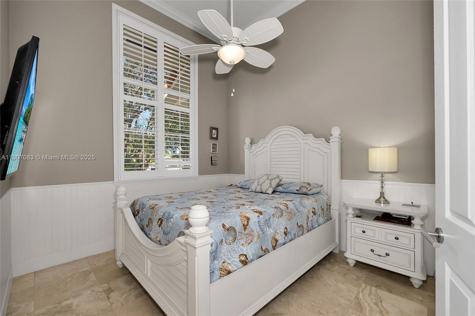 8025 Southwest 91 Avenue Miami, FL 33173 - Photo 22 of 51 a bedroom with a bed and a chandelier