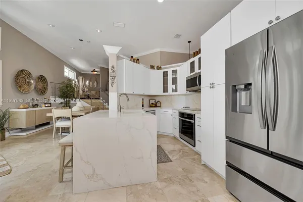 a kitchen with stainless steel appliances granite countertop a sink and stove top oven