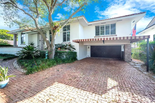 a front view of a house with a garden and outdoor seating