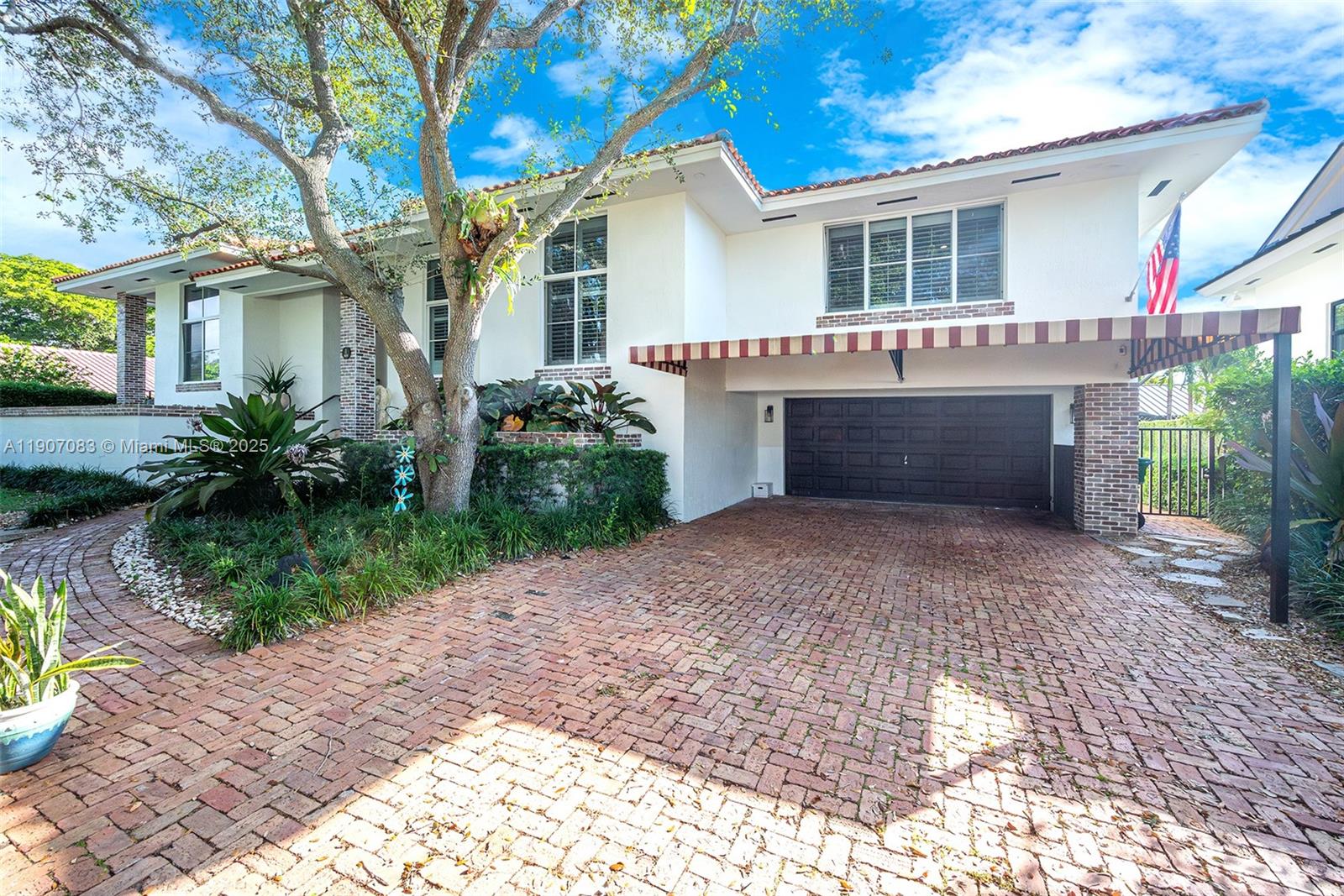 8025 Southwest 91 Avenue Miami, FL 33173 - Photo 3 of 51 a front view of a house with a garden and outdoor seating
