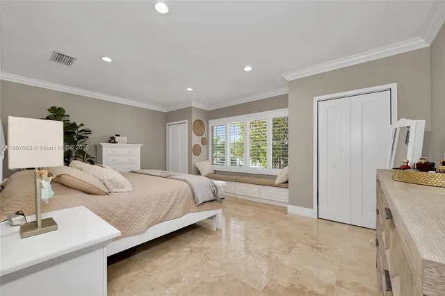 a spacious bedroom with a large bed and a couch