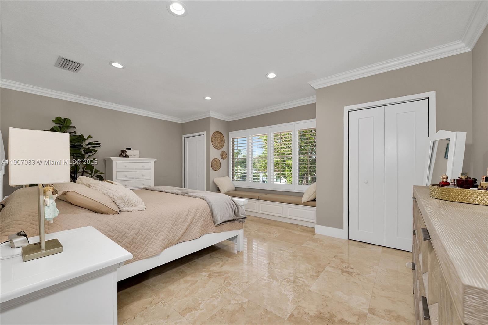 8025 Southwest 91 Avenue Miami, FL 33173 - Photo 31 of 51 a spacious bedroom with a bed and a sink with mirror