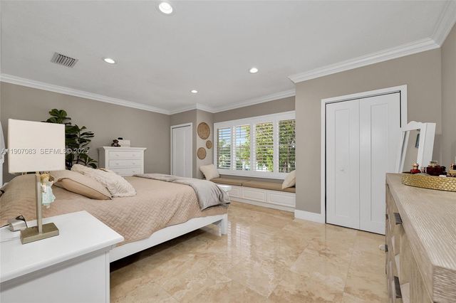 a spacious bedroom with a large bed and a couch