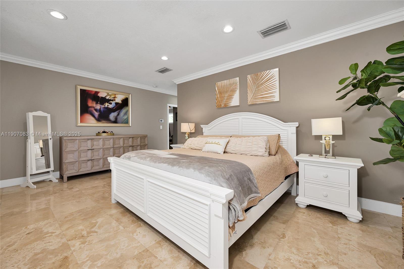 8025 Southwest 91 Avenue Miami, FL 33173 - Photo 32 of 51 a spacious bedroom with a large bed and a couch