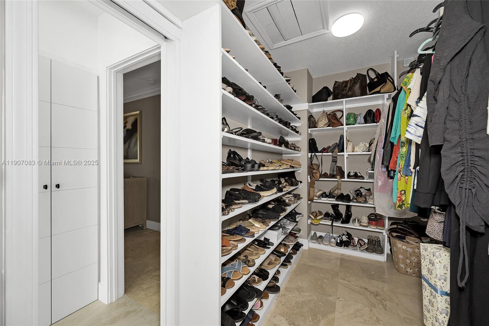 8025 Southwest 91 Avenue Miami, FL 33173 - Photo 35 of 51 a view of walk in closet with clothes and shoes