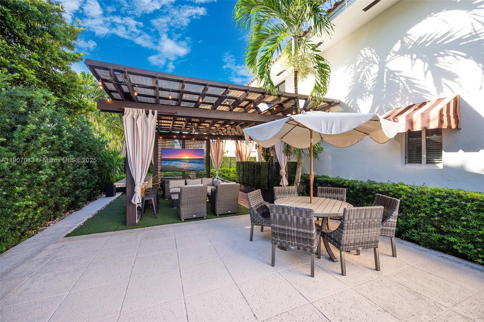 8025 Southwest 91 Avenue Miami, FL 33173 - Photo 44 of 51 a view of a patio with a table and chairs under an umbrella