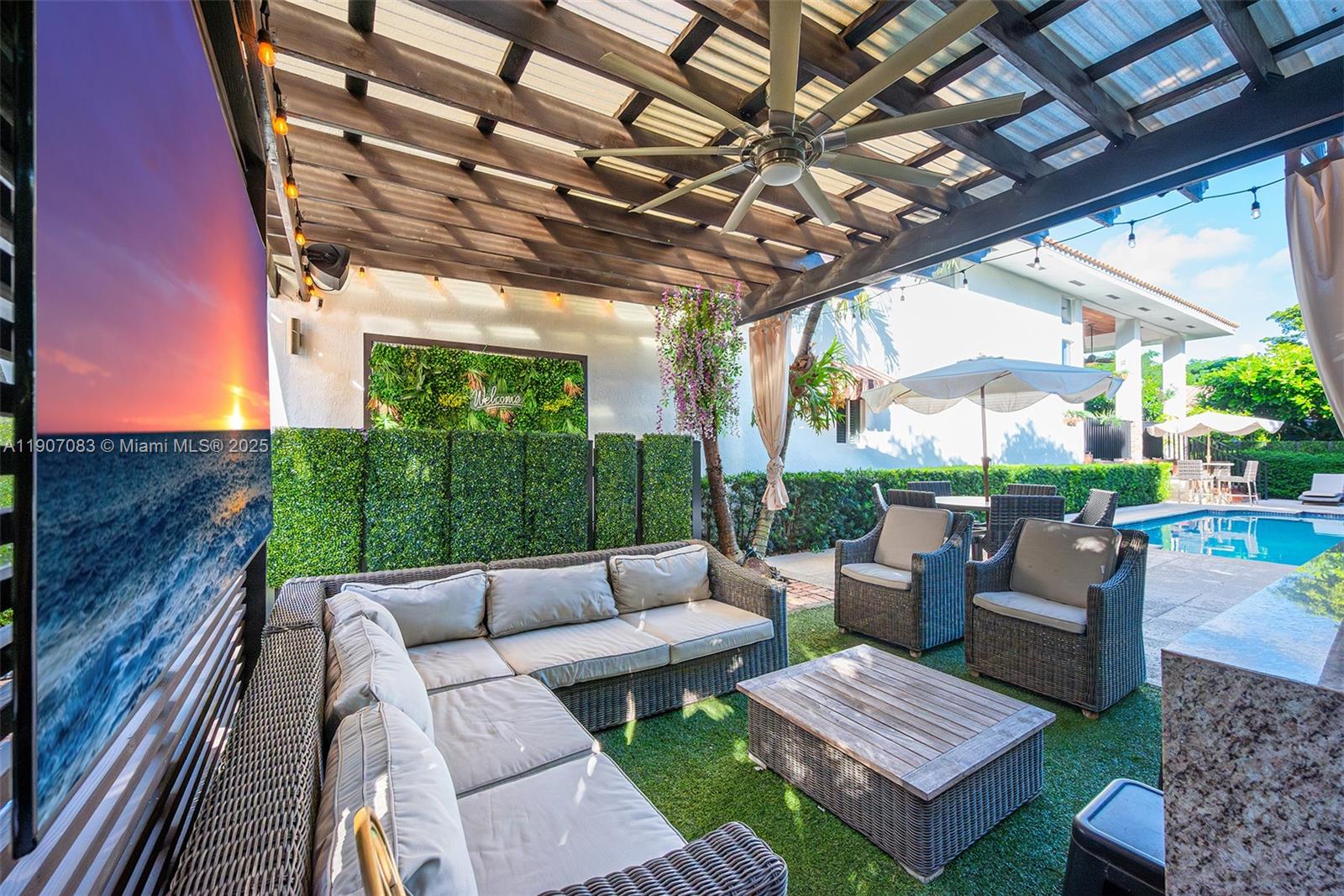 8025 Southwest 91 Avenue Miami, FL 33173 - Photo 45 of 51 a view of a patio with couches and a table and chairs with wooden floor fence and roof