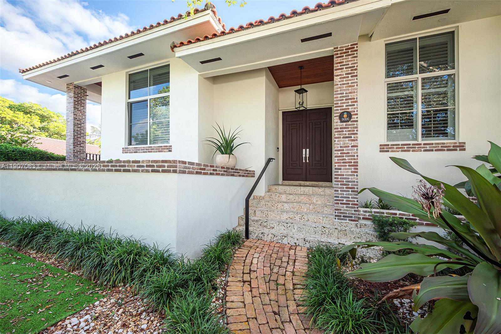 8025 Southwest 91 Avenue Miami, FL 33173 - Photo 6 of 51 a front view of a house with a garden