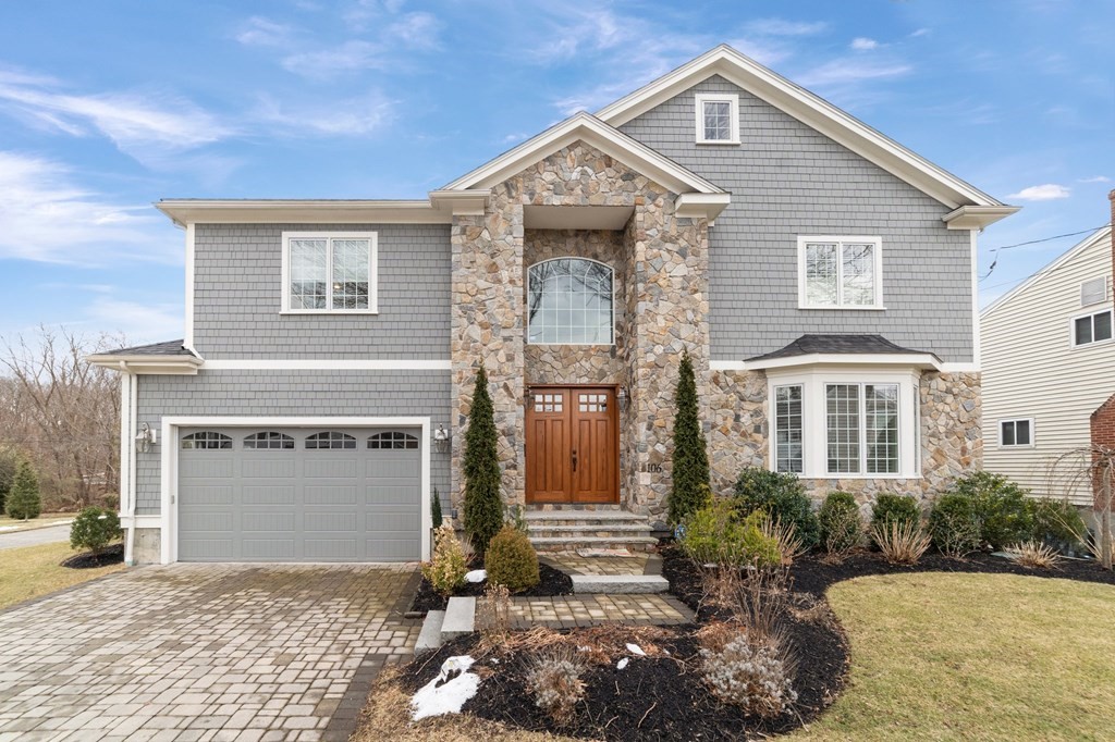 106 Pine Street Newton, MA 02465 - Photo 1 of 22 a front view of a house with a yard and garage