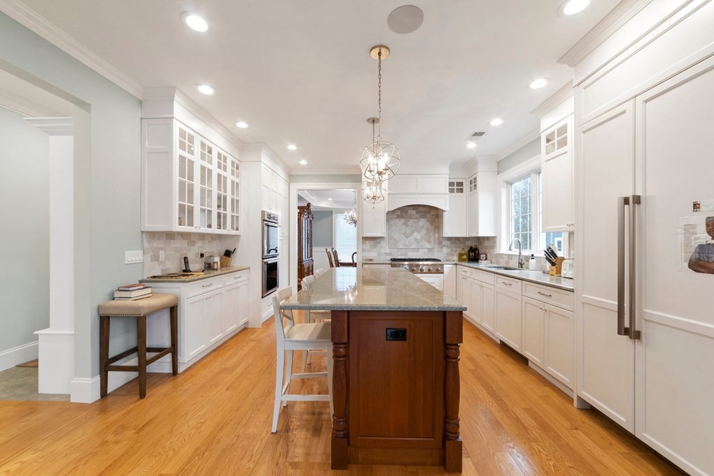 106 Pine Street Newton, MA 02465 - Photo 17 of 22 a kitchen with stainless steel appliances granite countertop a sink a stove a refrigerator and island with wooden floor