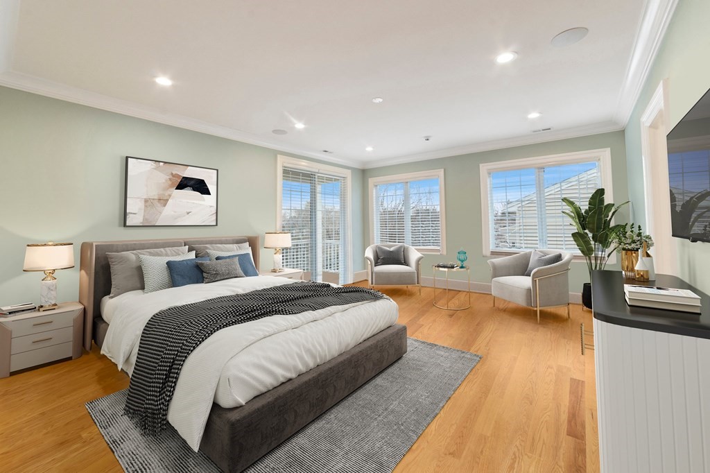 106 Pine Street Newton, MA 02465 - Photo 7 of 22 a spacious bedroom with a large bed a couch and potted plant with wooden floor
