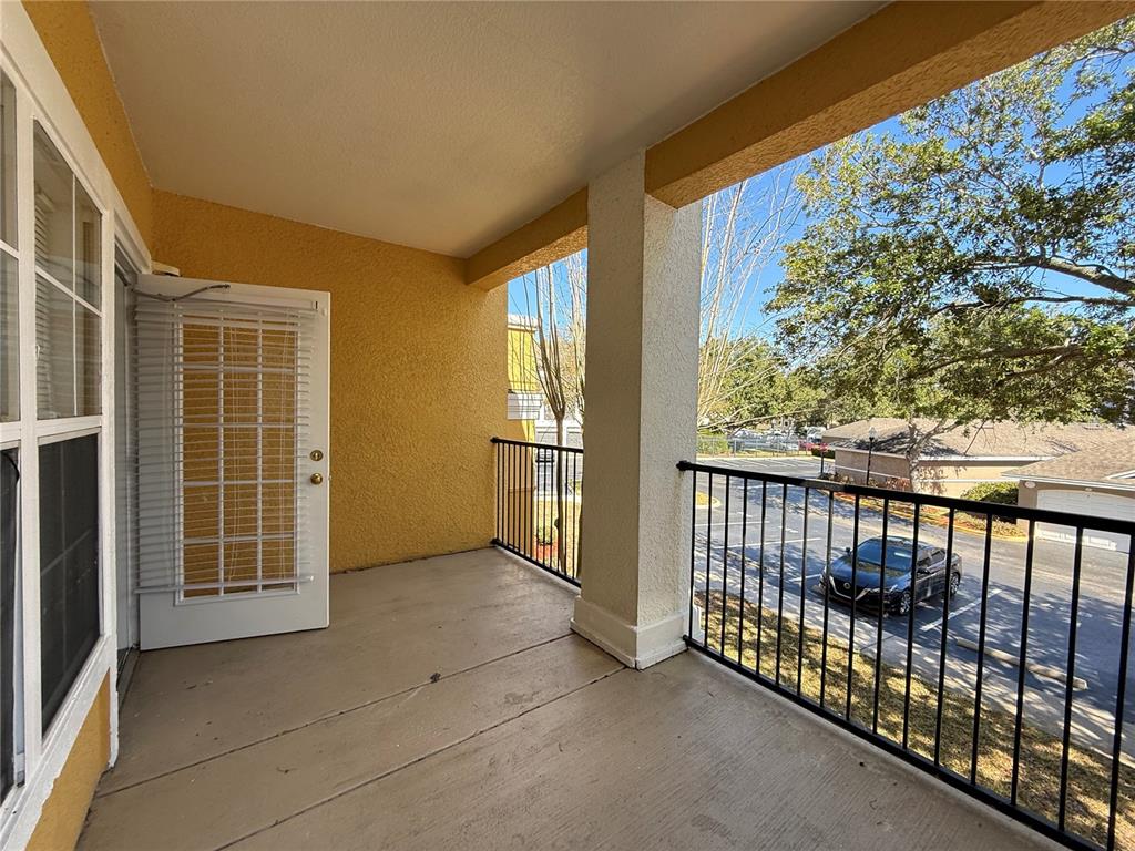 3611 Conroy Road, Unit 825 Orlando, FL 32839 - Photo 15 of 27 a view of a porch with wooden floor and iron fence