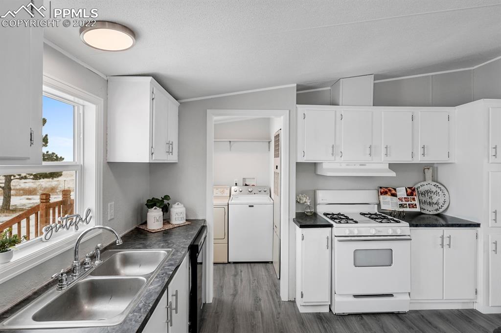 34010 Sanborn Road Yoder, CO 80864 - Photo 11 of 35 a kitchen with cabinets a sink and appliances