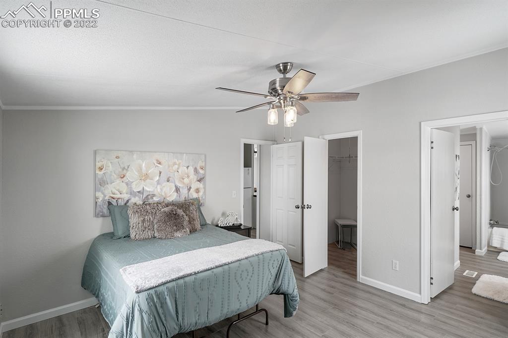 34010 Sanborn Road Yoder, CO 80864 - Photo 15 of 35 a bedroom with a bed and wooden floor