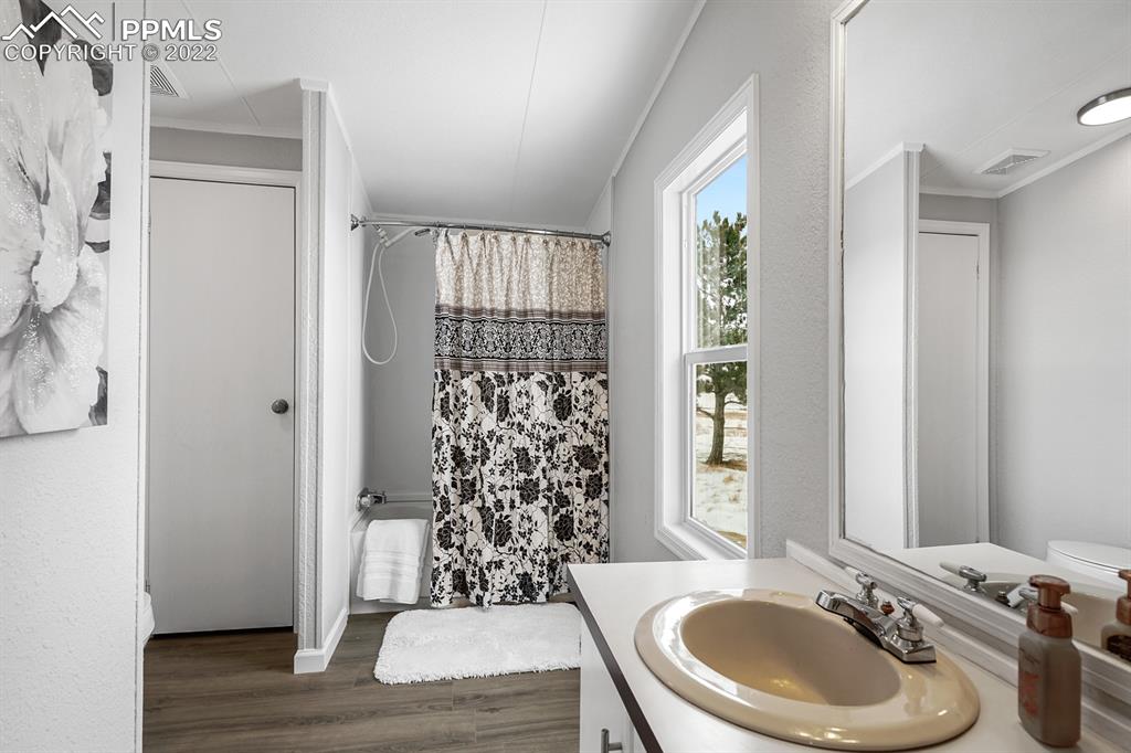 34010 Sanborn Road Yoder, CO 80864 - Photo 17 of 35 a bathroom with a sink toilet and a mirror