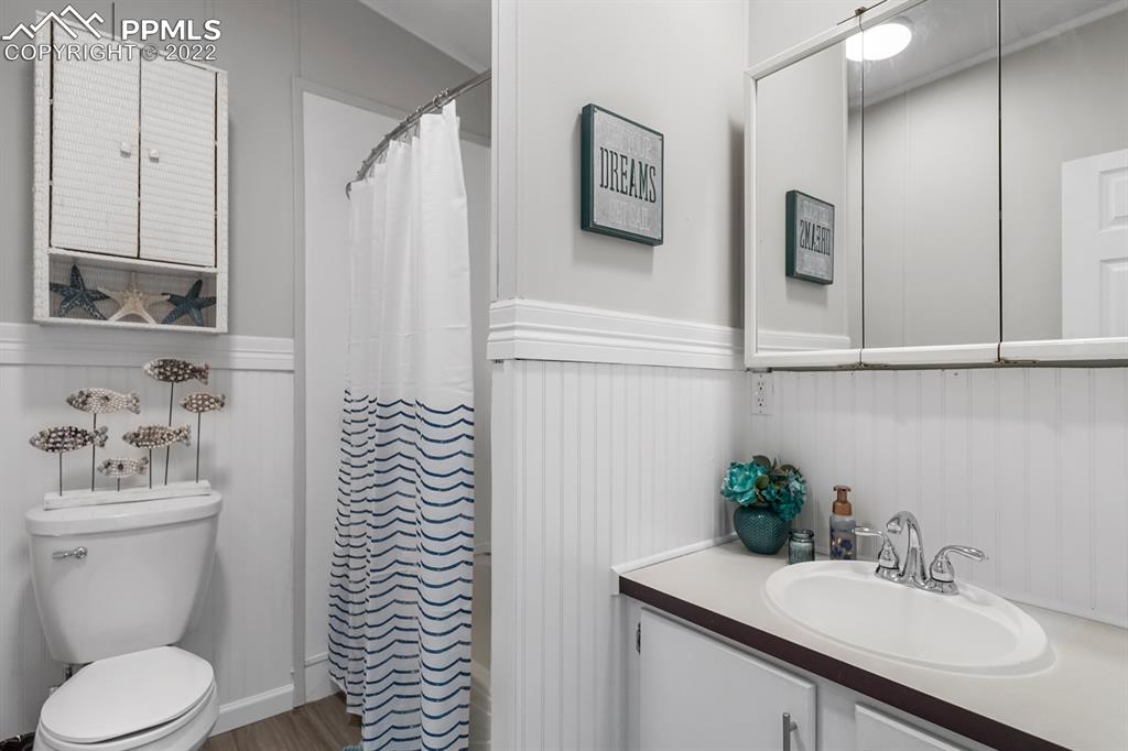 34010 Sanborn Road Yoder, CO 80864 - Photo 21 of 35 a bathroom with a sink a toilet and mirror