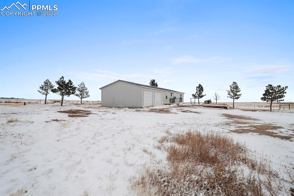 34010 Sanborn Road Yoder, CO 80864 - Photo 28 of 35 a view of a dry yard with a tree