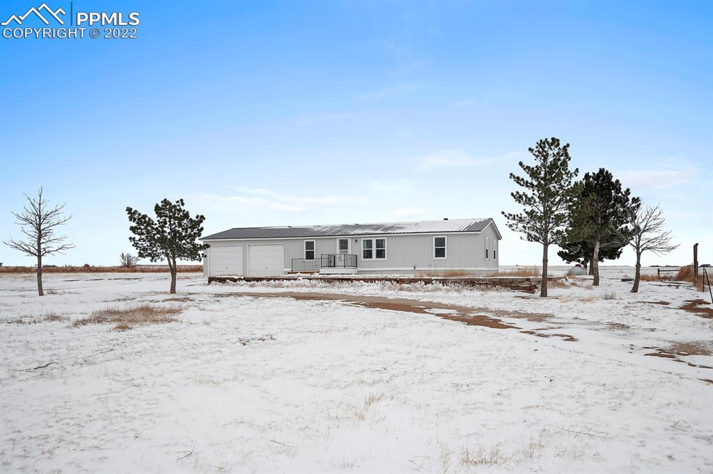 34010 Sanborn Road Yoder, CO 80864 - Photo 33 of 35 a view of a dirt road with a building in the background
